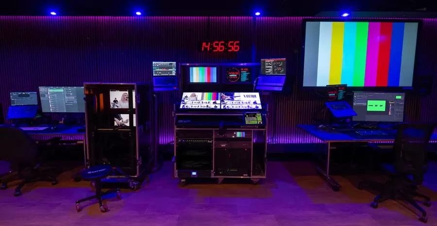 Surdevan's control room and office with PPU, vision mixer at Vectar Project. Multiple computer and broadcast systems, monitors and studio clock.