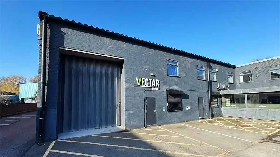 Exterior of Vectar Project Studio in Stockport. Scene dock doors and Vectar Project logo on the wall